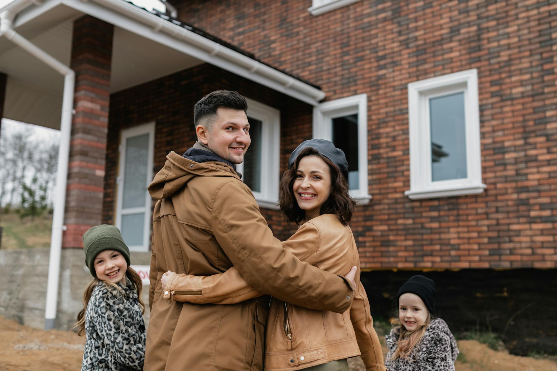 Happy family on the porch of their new home